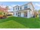 Two-story house back, showcasing a patio, lush lawn, and a fenced backyard at 8146 Prestbury Dr, Orlando, FL 32832