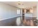 Open living room with hardwood floors and kitchen view at 8146 Prestbury Dr, Orlando, FL 32832