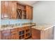 Wet bar with granite countertop and dark wood cabinets at 8146 Prestbury Dr, Orlando, FL 32832