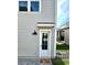 Exterior back door with a small patio and landscaping at 8226 Nemours Pkwy, Orlando, FL 32827