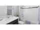 Clean bathroom with white tile, bathtub, and updated vanity at 8226 Nemours Pkwy, Orlando, FL 32827