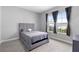 Bright bedroom with plush carpet and large windows at 8226 Nemours Pkwy, Orlando, FL 32827