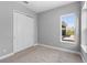 Simple bedroom with carpet, neutral walls, and double door closet at 8226 Nemours Pkwy, Orlando, FL 32827