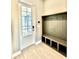 Entryway with built-in bench seating and coat hooks at 8226 Nemours Pkwy, Orlando, FL 32827