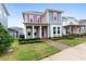 Two-story house with taupe and blue siding, pink shutters, and a covered porch at 8226 Nemours Pkwy, Orlando, FL 32827