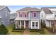 Two-story house with taupe and blue siding, pink shutters, and a covered porch at 8226 Nemours Pkwy, Orlando, FL 32827