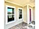 Front porch with pavers, a pink door, and large windows at 8226 Nemours Pkwy, Orlando, FL 32827