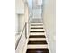 Modern staircase with dark wood treads and cable railing at 8226 Nemours Pkwy, Orlando, FL 32827