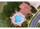 Community pool and clubhouse surrounded by lush landscaping at 8312 Via Rosa, Orlando, FL 32836