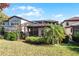 Spacious backyard featuring a screened patio and a well-manicured lawn at 8312 Via Rosa, Orlando, FL 32836