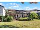 Landscaped backyard with screened patio and lush greenery at 8312 Via Rosa, Orlando, FL 32836