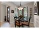 Small breakfast area with glass table and four chairs near a back door at 8312 Via Rosa, Orlando, FL 32836