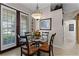 Small breakfast area with glass table and four chairs near a back door at 8312 Via Rosa, Orlando, FL 32836