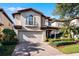 Two-story house with a light-colored facade, brown roof, and manicured landscaping at 8312 Via Rosa, Orlando, FL 32836