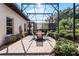 Enjoy the sunshine in this screened patio with seating area and brick pavers at 8312 Via Rosa, Orlando, FL 32836