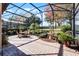 Relaxing screened patio with seating area, fountain, and lush landscaping at 8312 Via Rosa, Orlando, FL 32836