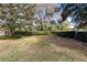 Landscaped backyard with lush lawn and privacy hedge at 846 Leopard Trl, Winter Springs, FL 32708