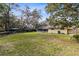 Large backyard with a grassy area and mature trees at 846 Leopard Trl, Winter Springs, FL 32708