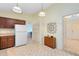 Kitchen with wood cabinets, white appliances, and tiled floor at 846 Leopard Trl, Winter Springs, FL 32708