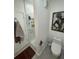 Bathroom featuring modern toilet, glass enclosed shower with shelves, and stylish lighting at 860 N Orange Ave # 163, Orlando, FL 32801