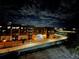 Nighttime view of an apartment complex featuring a bridge, street lights, and a dark, cloudy sky at 860 N Orange Ave # 163, Orlando, FL 32801