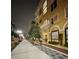 Elegant apartment complex with stylish architecture, lush landscaping, and a well-lit sidewalk at nighttime at 860 N Orange Ave # 163, Orlando, FL 32801