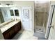 Double vanity bathroom with granite countertops and a large shower at 8973 Azalea Sands Ln # 8973, Davenport, FL 33896