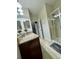 Bathroom with granite countertops, double sinks, and a large shower at 8973 Azalea Sands Ln # 8973, Davenport, FL 33896