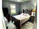 Bedroom with a king-size bed, TV, and dark grey walls at 8973 Azalea Sands Ln # 8973, Davenport, FL 33896