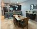 Dining area with a rustic wooden table and chairs, adjacent to the kitchen at 8973 Azalea Sands Ln # 8973, Davenport, FL 33896