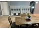 Bright dining room features a rustic wood table with bench seating and built-in shelving at 8973 Azalea Sands Ln # 8973, Davenport, FL 33896