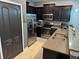 Modern kitchen with dark wood cabinets and stainless steel appliances at 8973 Azalea Sands Ln # 8973, Davenport, FL 33896