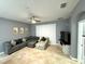 Relaxing living room with a sectional sofa and large TV at 8973 Azalea Sands Ln # 8973, Davenport, FL 33896