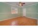 Light and airy bedroom with hardwood floors and ceiling fan at 926 Freshmeadow Ct, Apopka, FL 32703