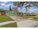 Green house with a driveway and sidewalk at 926 Freshmeadow Ct, Apopka, FL 32703