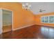 Living room with hardwood floors and access to another room at 926 Freshmeadow Ct, Apopka, FL 32703