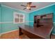 Home office with built-in desk and hardwood floors at 926 Freshmeadow Ct, Apopka, FL 32703