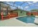 Refreshing swimming pool with a screened enclosure and wooden deck at 926 Freshmeadow Ct, Apopka, FL 32703