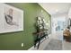 Modern entryway with green walls, a console table, and artwork at 10136 Huntingnet Way, Leesburg, FL 34748