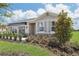 House exterior showcasing landscaping and a stylish awning at 10136 Huntingnet Way, Leesburg, FL 34748