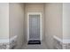 Gray front door entryway with stone accents at 10136 Huntingnet Way, Leesburg, FL 34748