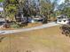 Aerial view of property showing home, driveway, and surrounding trees at 1016 W Lake Marion Rd, Haines City, FL 33844