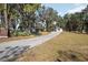 Driveway to home surrounded by trees at 1016 W Lake Marion Rd, Haines City, FL 33844