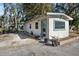 Small house with a green door and windows, nestled in a wooded area at 1016 W Lake Marion Rd, Haines City, FL 33844