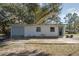 Single story house with attached garage, featuring a grey door and windows at 1016 W Lake Marion Rd, Haines City, FL 33844