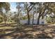 View of home's exterior with surrounding trees at 1016 W Lake Marion Rd, Haines City, FL 33844