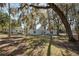 Rear view of home with mature trees at 1016 W Lake Marion Rd, Haines City, FL 33844