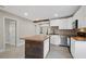 Modern kitchen with white cabinets, wood island, and patterned backsplash at 1016 W Lake Marion Rd, Haines City, FL 33844