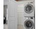 Bright laundry room with shelving and stackable washer and dryer at 1016 W Lake Marion Rd, Haines City, FL 33844