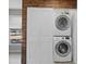 Stackable washer and dryer in a laundry room with wood accent wall at 1016 W Lake Marion Rd, Haines City, FL 33844